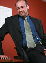 Billy Duro posing naked in a office