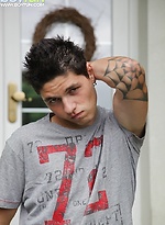 Tattooed stud Jeremy stroking his cock outdoors.